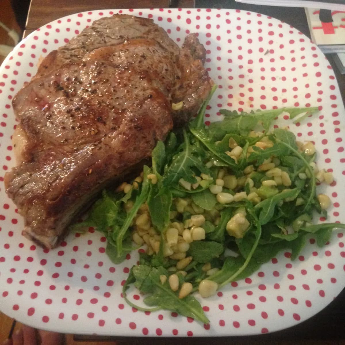 Pan seared rib-eye steak with roasted corn, avocado and arugula