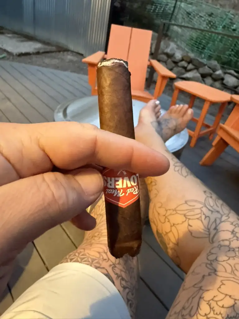 A Red Meat Lovers Filet Mignon on the deck at dusk, orange chairs and the ashtray behind it